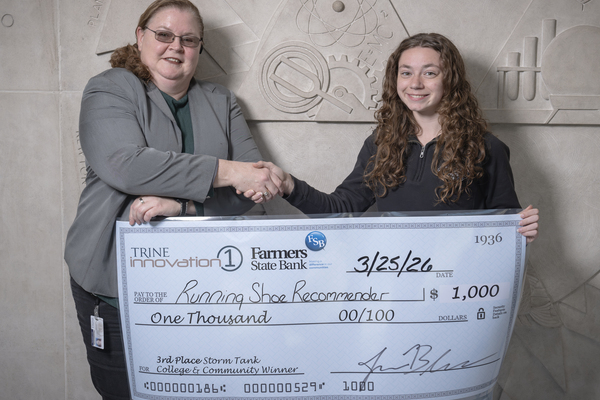 Cynthia Netcher, left, administrative assistant for Trine innovation 1, presents the check for the third-place award at Trine University’s annual college and community Storm Tank to Piper Barker, a chemical engineering major from Evansville, Indiana. (Photo by Dean Orewiler / Trine University)