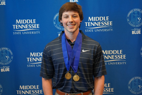 smiling student wearing medals