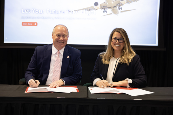Jacksonville State President Dr. Don C. Killingsworth, Jr. and Jessica Sanders Walker, President of Sanders Flight Training Center sign an MOU at Jax State's quarterly Board of Trustees Meeting.