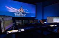 Image of a sound mixing station with a large screen in the background, showing a still image of the Disney Animation title screen.