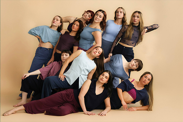 Dance students posing as a group in dance attire.