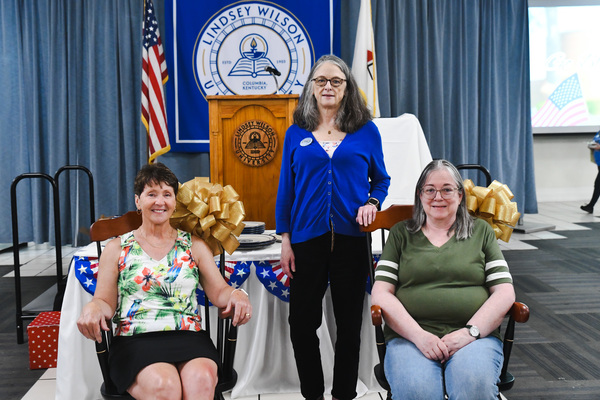 Four Lindsey Wilson University employees who are retiring during the 2025-26 academic year were honored with a university-branded rocking chair at the annual Employee Appreciation Dinner, held Wednesday, April 16, in the Roberta D. Cranmer Dining & Conference Center. From left: Sharon Shields-Smock, assistant registrar with 15 years of service; Susan Vickous, assistant professor of nursing with 10 years of service; Kerry Robertson, associate professor of english with 30 years of service. Not pictured: Judy Bryant, an a.m. server with 15 years of service.
