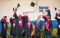 Graduates throw their mortarboards into the air during a Commencement ceremony.