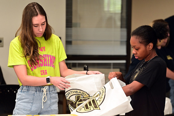 Northeast Mississippi Community College Iota Zeta chapter of the Phi Theta Kappa honor society members pack orders from the organization's Spring 2026 cheese sale. 