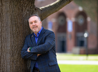 Thomas Burns poses for a portrait in the Academic Quad at SUNY Potsdam.