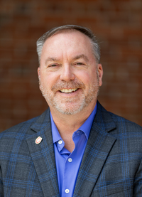 Thomas Burns poses for a portrait in the Academic Quad at SUNY Potsdam.