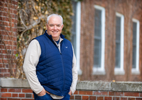 John Finnegan poses for a portrait in the Academic Quad at SUNY Potsdam.