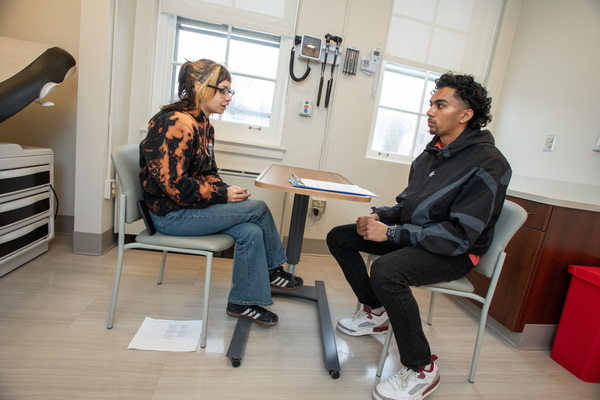 Student Q Asberry serves as a standardized patient for social work major Dustin Sannasi in a clinical simulation. 