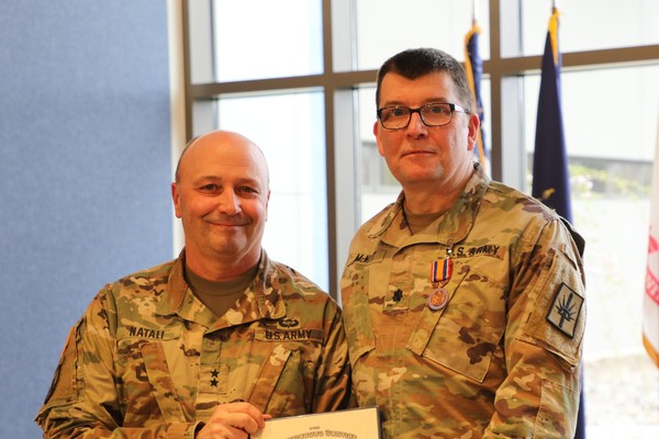 Lt. Col. Dage McNitt, right, a Ballston Lake resident who retired from the New York Army National Guard on April 20 after 38 years of service, receives the New York State Conspicuous Service Medal from Major General Michel Natali, the assistant adjutant general, Army. ( U.S. Army National Guard photo by Stephanie Butler)