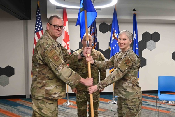 Col. Jennifer L. King,right, the new commander of the Eastern Air Defense Sector, receives the organization's guidon from Lt. Gen. Luke Ahmann, the commander of the Continental U.S. North American Aerospace Defense Command Region during a change of command ceremony at the Griffiss Institute Innovare Advancement Center, April 17, 2026. The Rome-based Eastern Air Defense Sector is responsible for the air defense of the United States east of the Mississippi.(U.S. Air National Guard photo by Barbara Olney)    