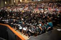 A full theater of people at the Bologna Performing Arts Center for a commencement ceremony.