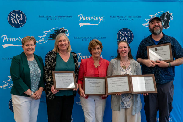 This year’s award winners pose with their certificates alongside Janet Clark, provost/executive vice president for academic affairs, left. Winners, from second left, are Chris Delnat, Ph.D., RN, associate professor and director of undergraduate nursing, Kathleen Pickrell, adjunct nursing faculty member, Keeley Cleghorn, Ph.D., assistant professor of science and math, and Robert Vandermolen, Ph.D., assistant professor of mathematics.