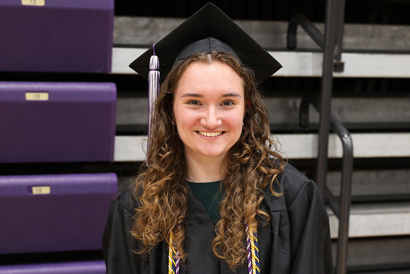 Emily Krizner holiding award