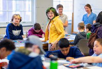 College students oversee children working on projects during an art field trip to SUNY Potsdam.