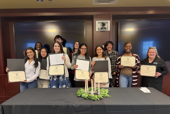 Students holding their induction certificates