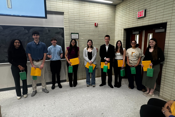Students inducted into TriBeta holding their certificates