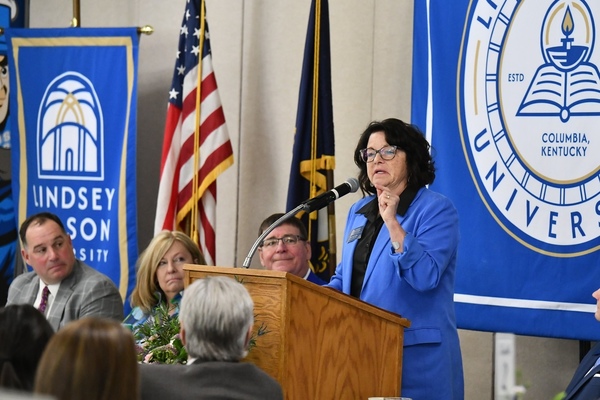 Lindsey Wilson Dean of Students Dr. Traci Luckey ’91 Pooler delivers the 2026 Lindsey Wilson University Founders’ Day Celebration keynote address on Thursday, April 23, at Roberta D. Cranmer Dining & Conference Center. Looking on is Dr. Pooler’s husband, LWU Athletics Director Willis Pooler, LWU First Lady Elise Luckey and President William T. Luckey Jr.