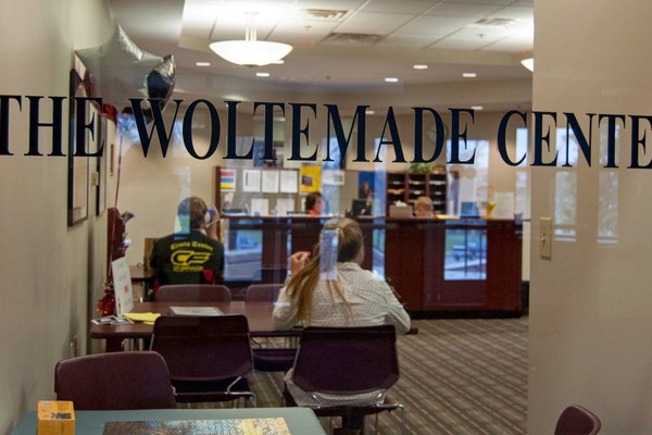 The photographer's image shows a look through the office window for Ohio Wesleyan's Woltemade Center with the center's name lettered on the glass.
