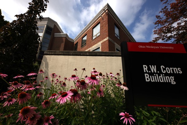 Exterior photo of Ohio Wesleyan's R.W. Corns Building with coneflowers in the foreground.