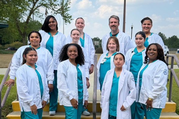 Group of twelve Central Sterile Supply Processing Technician graduates pose for a photo on the steps at SRTC-Tifton