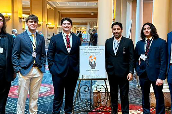 Group photo of Angelo State economics students and their professor at the APEE Conference