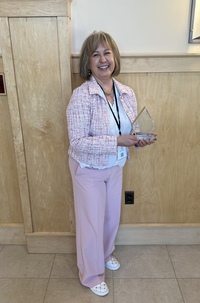 Theresa Adams poses with her New York State Student Excellence in Public Health Award.