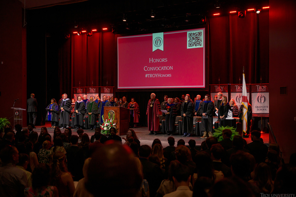 Students on stage in Claudia Crosby Theatre on the Troy Campus during Honors Convocation.