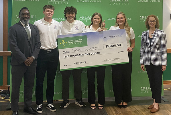McDaniel College student winners of the Innovation and Entrepreneurship Challenge holding their top prize, a $5,000 check.