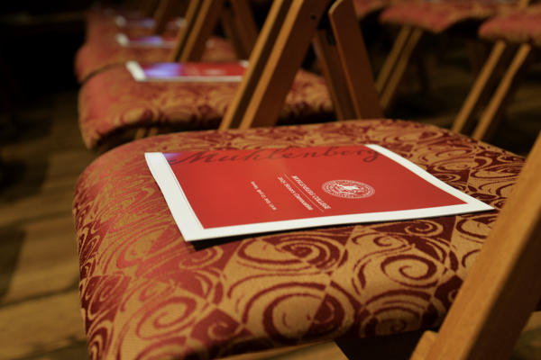 An honors booklet lays on a chair.