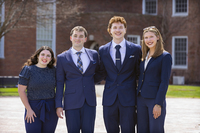 Students in business attire pose for a photo in the Academic Quad.