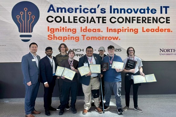 A group of students from Oregon Tech holding up awards