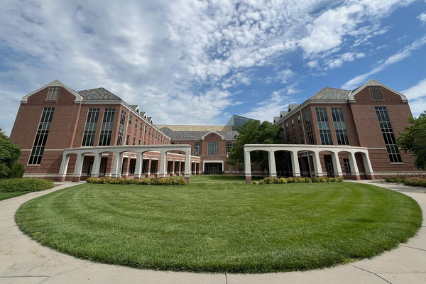 An exterior photo of the south side of the Kauffman Academic Residential Center on a partly cloudy day.