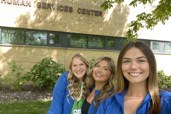 EIU senior Sydney Hanfland (left) with peers Ani Kerr (middle) and Paige Cooper (right) outside the Human Services Building.