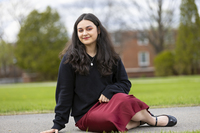 Alyssa Spina poses for a photo in the Academic Quad at SUNY Potsdam.