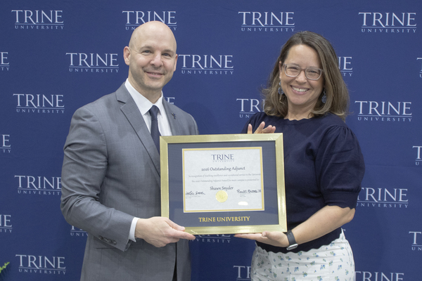 Shawn Snyder, right, adjunct faculty member in Trine University's Franks School of Education, accepts the Outstanding Adjunct Award from Tony Kline, Ph.D., president-elect of Trine University. (Photo by James Tew / Trine University) 