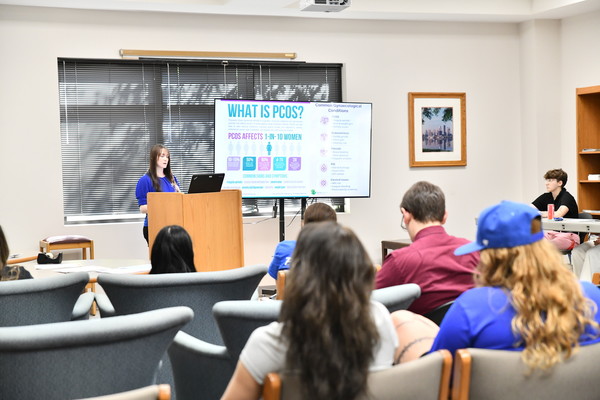 Psychophysiology senior Cassidy Harrison of Park City, Kentucky, presents at the 13th annual Dr. Kara Mollis Women and Gender Studies Conference Held on April 22. More than a dozen students took part in the day-long conference that was named in honor of the late Lindsey Wilson English faculty member Kara Mollis, who passed away in 2021.
