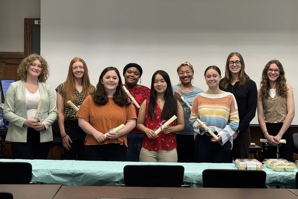 McDaniel college students inducted into Psi Chi international honor society in psychology, pictured standing in a group holding their certificates. 