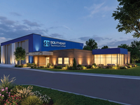 Brick building with blue siding and college logo.