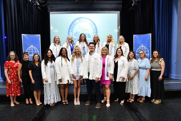 Pictured: Lindsey Wilson University Class of 2025 nursing graduates, pictured in May 2025 with the university nursing faculty. The 12 nursing graduates achieved a 100% pass rate on the National Council Licensure Examination (NCLEX), the nationwide examination for the licensing of nurses in the United States.