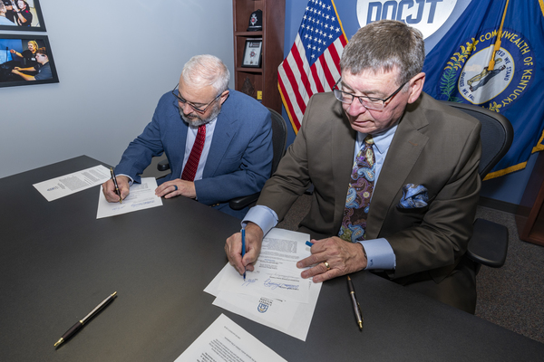 Brian Bowling, Department of Criminal Justice Training Deputy Commissioner, left, and William T. Luckey Jr., Lindsey Wilson University President, sign a partnership agreement on Tuesday, May 5, to expand educational opportunities for employees of DOCJT. The agreement, announced at the training center in Richmond, Kentucky, allows DOCJT employees and their immediate family members to receive scholarship support through Lindsey Wilson University’s educational outreach programs offered in traditional, online or hybrid formats. 