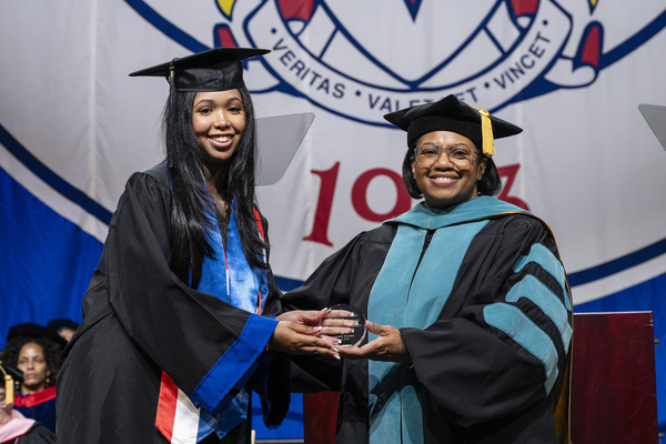 Anmariely Montano presented award by Provost Nicolle Parsons-Pollard