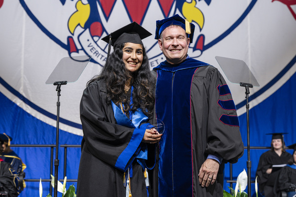 Puja Raol (left) receives award from Michael Sanseviro (right)