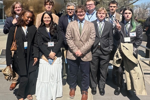 Students and professor pose for photo.