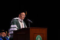 DSU President Dan Ennis at the podium addressing graduates