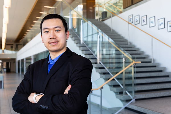 Portrait of Addison Yang standing in front of a staircase.