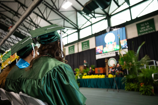 Graduates viewing the Commencement ceremony.
