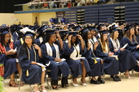 Graduates in the first two rows listening to commencement services.