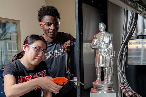 LEARNING BY DOING: Engineering majors Gianna Maughan and Adrian Outlaw demonstrate how one of the tools that Jupiter has provided the college can be used.