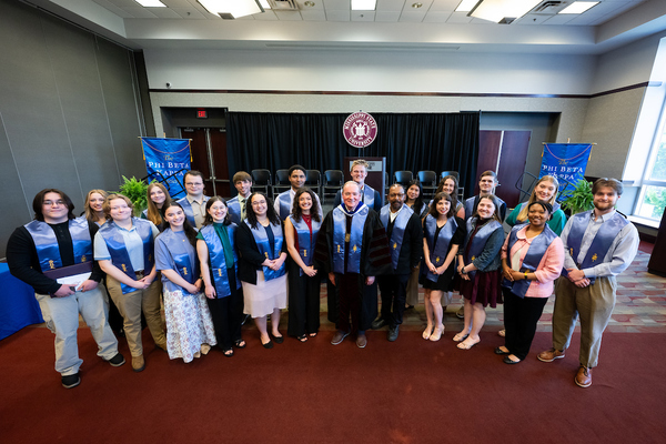 A group photo of MSU's 2026 PBK inductees, pictured with the university president and a faculty member also inducted as an honorary PBK member