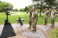 Soldiers salute after presenting Memorial Day wreath. 